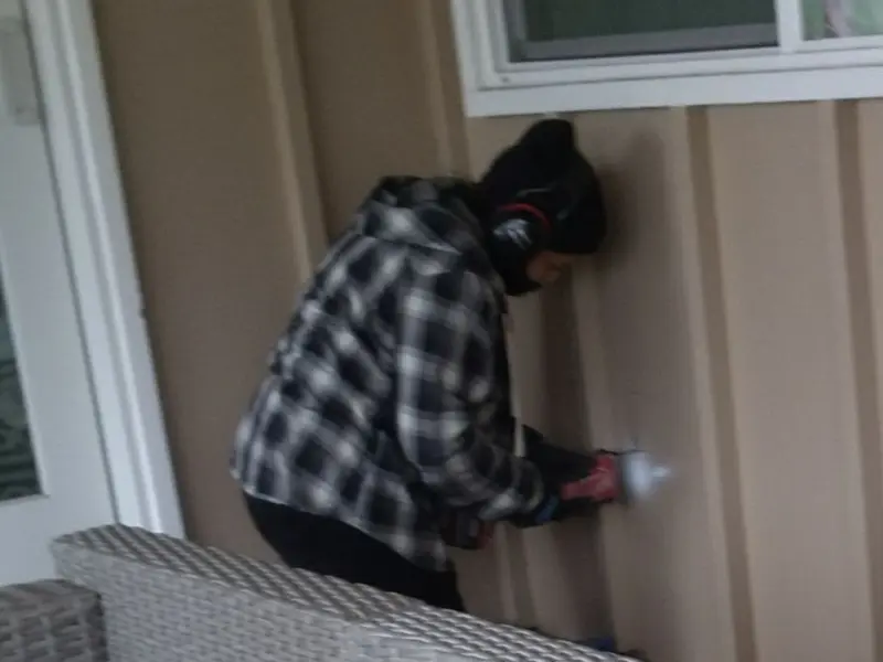 Professional electrician installing an exterior outlet in Bethel